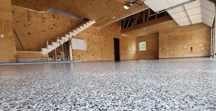 Residential epoxy flake flooring installed in Palmetto, FL with a durable, seamless finish for garages and workshops.