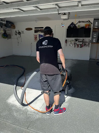 Technician installing durable garage floor coatings with decorative epoxy finish in Bradenton, FL for a seamless, long-lasting surface.
