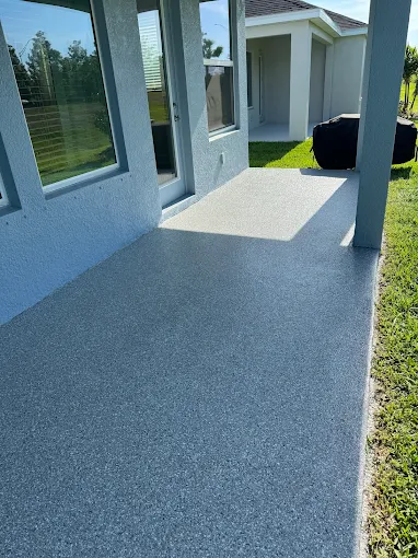Residential patio with durable epoxy coating and decorative flake finish installed in Ruskin, FL for long-lasting outdoor protection.